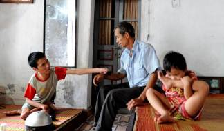Grandfather Tran is taking care of his handcapped son Ha, 27 as well as his 6 year old granddaughter Lam. Lam is born without an anus and severely deformed. Neither Ha nor Lam can speak. A family with 2nd and 3rd generation victims of Agent Orange.
